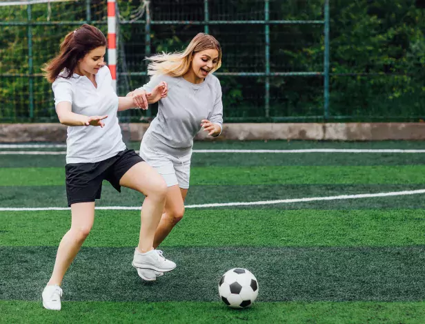 two-young-female-soccer-players-field