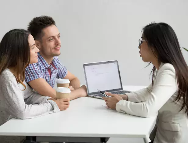 smiling-millennial-couple-listening-to-asian-advisor-lawyer-consulting-customers